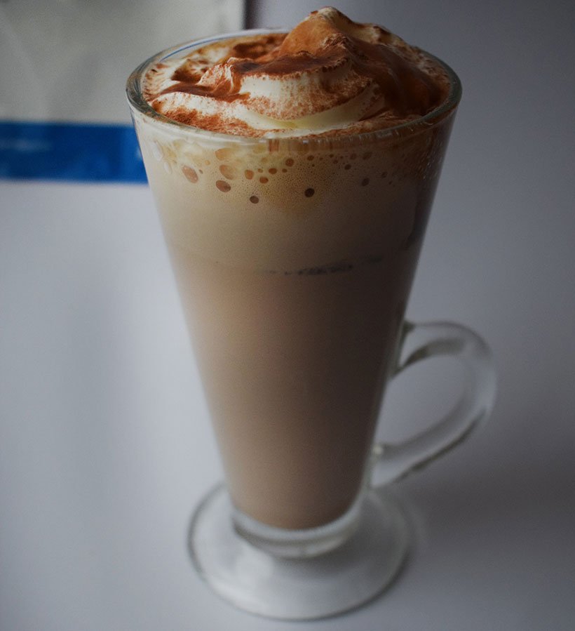 Myprotein protein hot mocha in glass with cream, syrup and powder