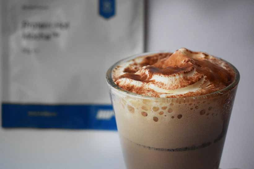 Myprotein protein hot mocha in glass with cream, syrup and powder