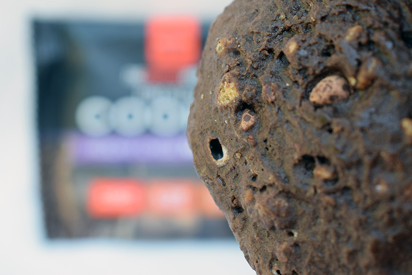 The protein works protein snacks Protein cookie Rocky Choc Mashup Flavour packaging and cookie closeup