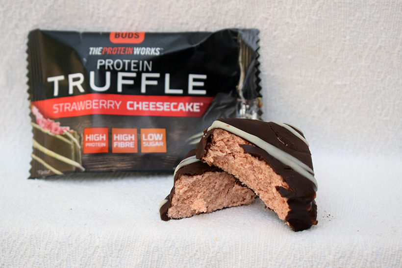 The protein works protein snacks Protein truffle strawberry cheesecake flavour inside
